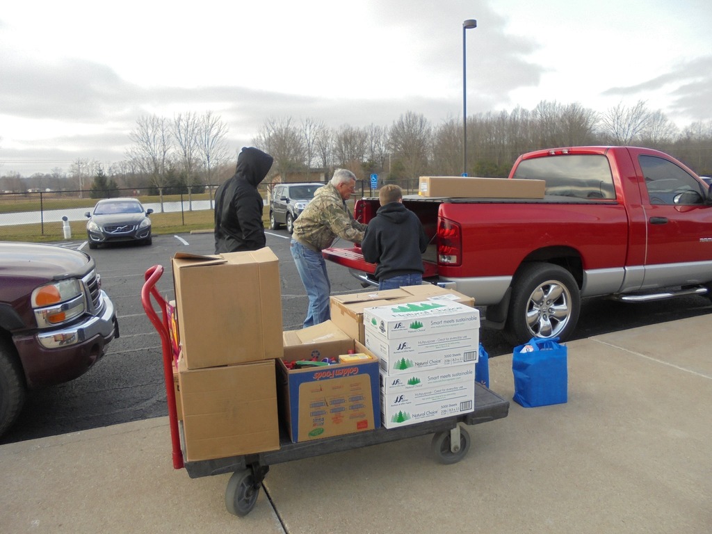 photo of students loading food into a truck